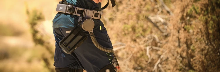 Man wearing Ascentiz exoskeleton with bags and other gadgets attached