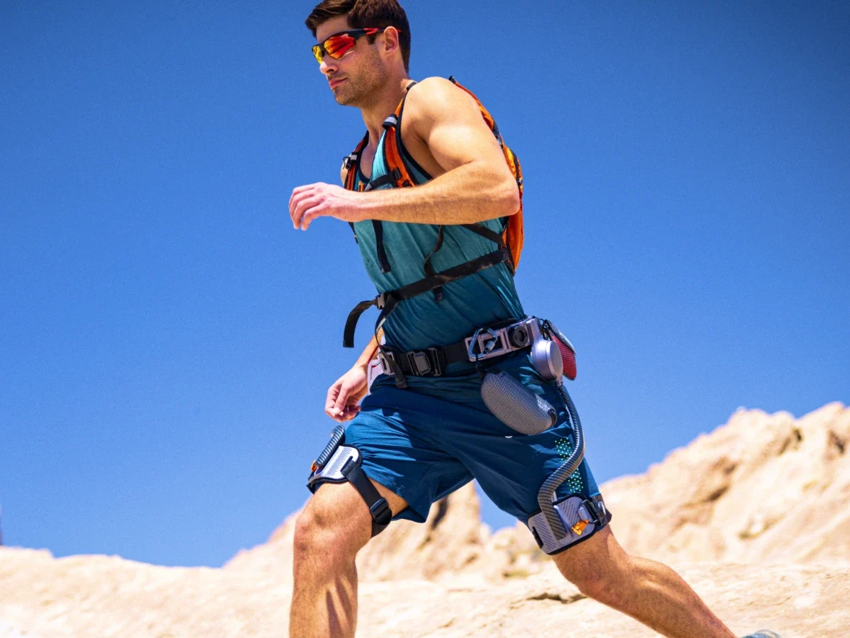 Man running on rocky terrain wearing the Ascentiz Hip Exoskeleton
